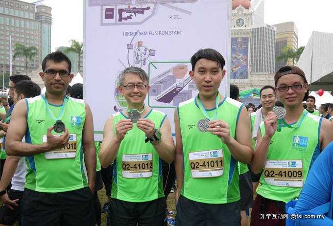 (L-R) Dr Muhammad, Professor Man, Jameson and Bejay posing with their medals at the end of the marathon.