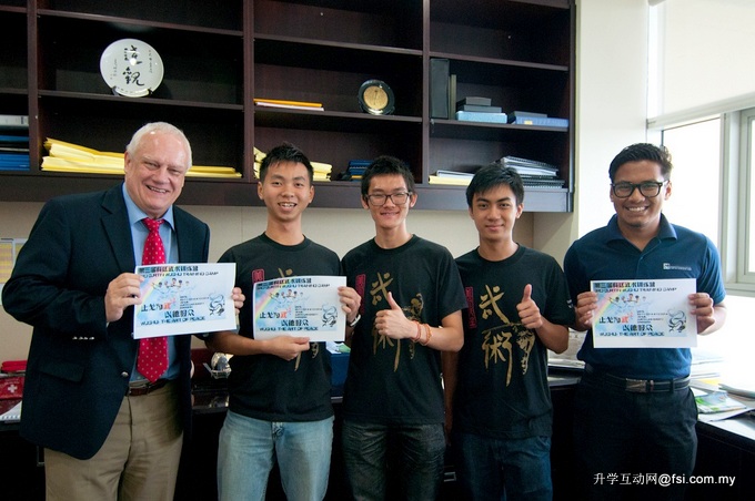 Curtin Sarawak’s Pro Vice-Chancellor Professor Jim Mienczakowski and the Wushu Training Camp organising committee members displaying the event promotional poster. 