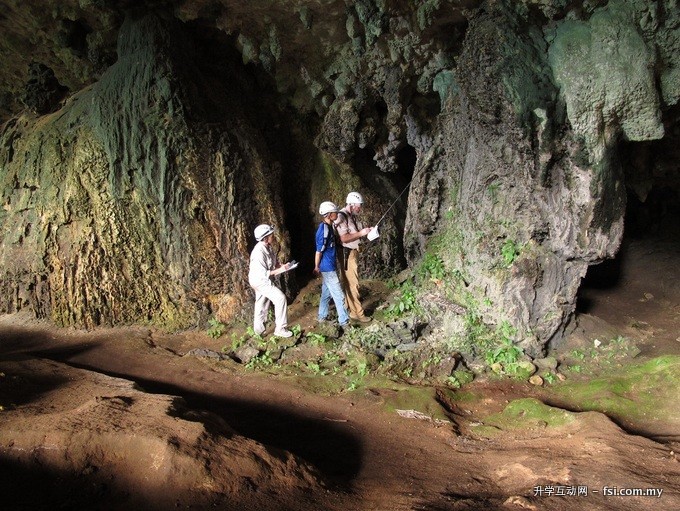 Dr. Kazmer, Dr. Dodge-Wan and Chu examining cave wall features in the Traders Cave at Niah.