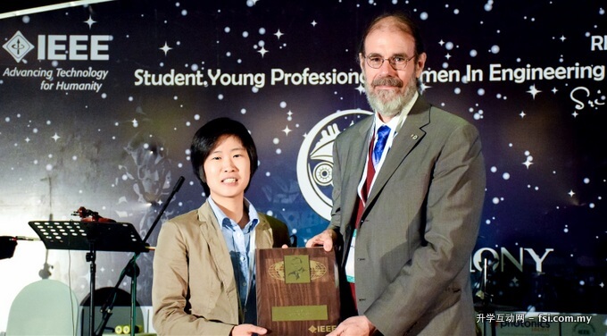 Ling receiving Larry K. Wilson Award from IEEE Past Presient Professor Michael Lightner. 