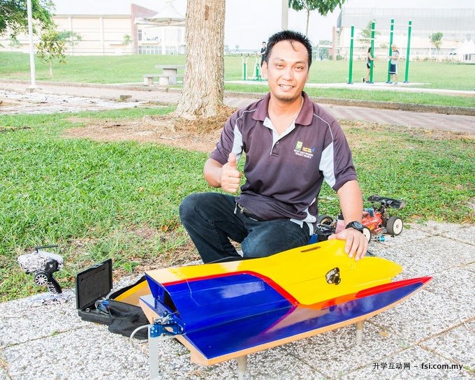 Member of the Miri radio Control Club displaying a radio control boat that will be competing in the boat race.