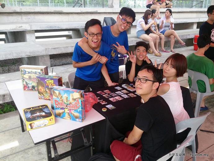 Participants at the card game competition booth.