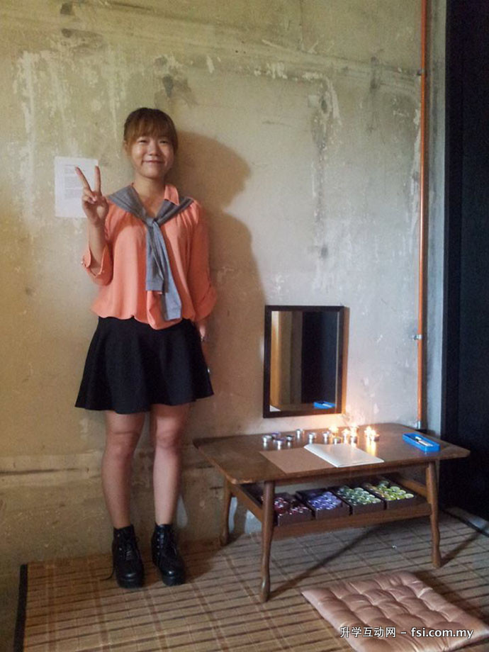 Student Andrea Kok and her candle-blowing installation to inspire forgiveness.
