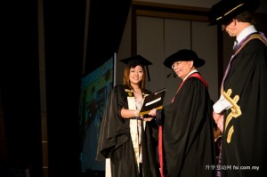 Dr Chan presenting a graduate her award while Dr Jim Gill looks on