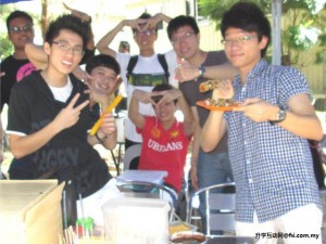 Liew (left) and fellow students promoting frozen ice sticks