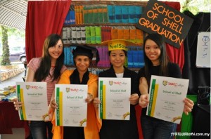 拉曼学院参赛者展示她们参加网络游戏后的“毕业”证书、毕业袍及四方帽。