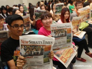 UTAR students posing with NST newspapers
