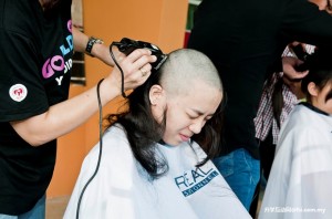 Alvina Wong getting her head shaved.
