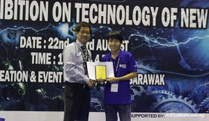 Electronic and communication engineering student Basil Andy Lease receiving the Project of the Year Award from Ng Kam Loong of X-FAB.