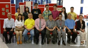 Representatives from ICS, the Tieu family and their friends taking a group photo at the exhibition