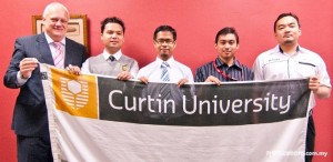 Professor Mienczakowski (left), Dr. Sharul (far right) with members of the Curtin Eco Racing Team.