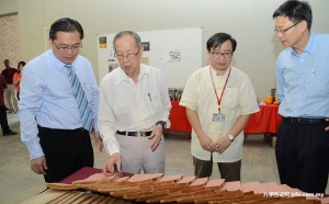 Tan Sri Hew (second from left) introducing his book collection to Dr Chong (left) while Dr Lim (third from left) and Hew look on